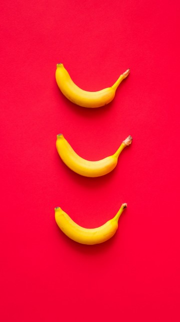 Premium Photo | Banana wallpaper on a pink background